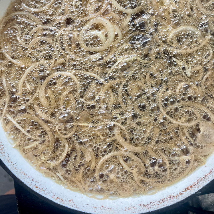 Image of Remove the cooked slices to the draining bowl and continue working in batches until all potatoes and onions are cooked and drained.